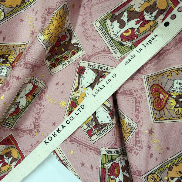 Selvage of In the Darkness Tarot Cats cotton fabric by Kokka in mauve, YGA-91050 B
