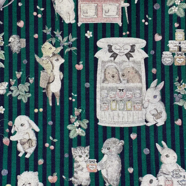 Close up of Jam Lab cotton linen fabric by Yukiemon for Hokkoh featuring a whimsical critter tea party with animals making jam on a green striped background, imported from Japan