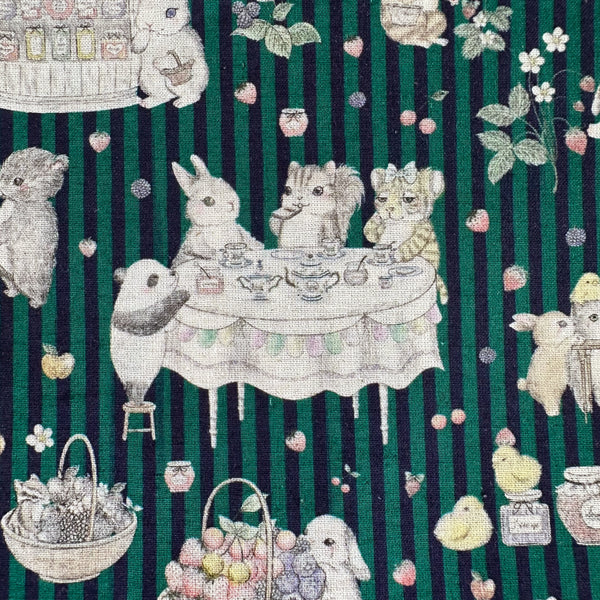 Close up of Jam Lab cotton linen fabric by Yukiemon for Hokkoh featuring a whimsical critter tea party with animals making jam on a green striped background, imported from Japan