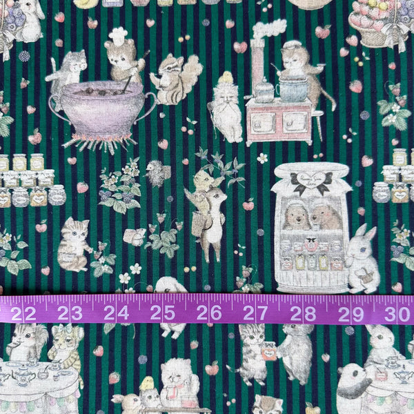 Scale of Jam Lab cotton linen fabric by Yukiemon for Hokkoh featuring a whimsical critter tea party with animals making jam on a green striped background, imported from Japan
