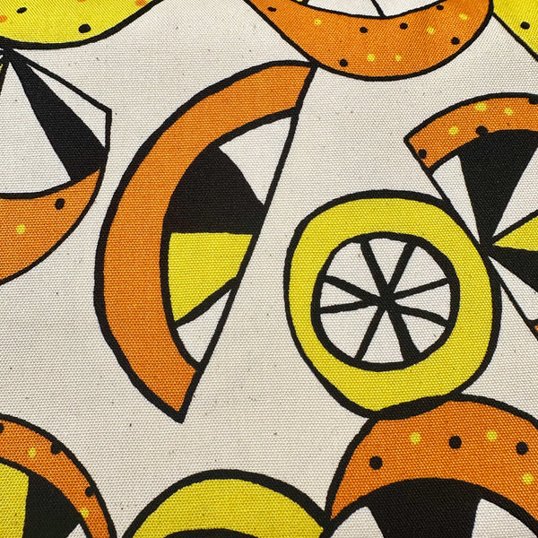 Close up of cotton oxford fabric featuring a lemon and lime print in yellow and green on a natural background, Imported from Japan