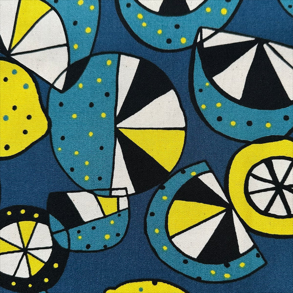 Close up of Imported from Japan, cotton oxford fabric featuring a lemon and lime print in yellow and green on a teal background