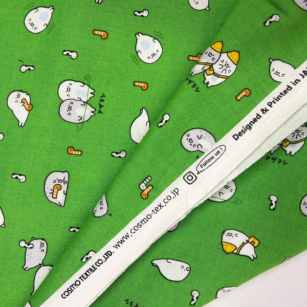 Selvage of Kawaii Seals cotton fabric by Cosmo Textiles in green, AP61103 2E
