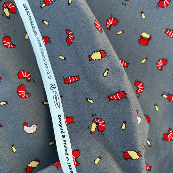 Selvage of Kawaii Shrimp Cotton Fabric by Cosmo Textiles, style AP61103H 1E, featuring shrimp illustrations, in gray