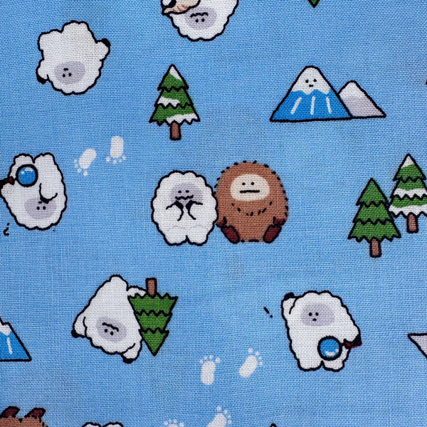 Close up of Kawaii Yeti Cotton Fabric by Cosmo Textiles, style AP65105 2C, featuring yeti illustrations, in blue