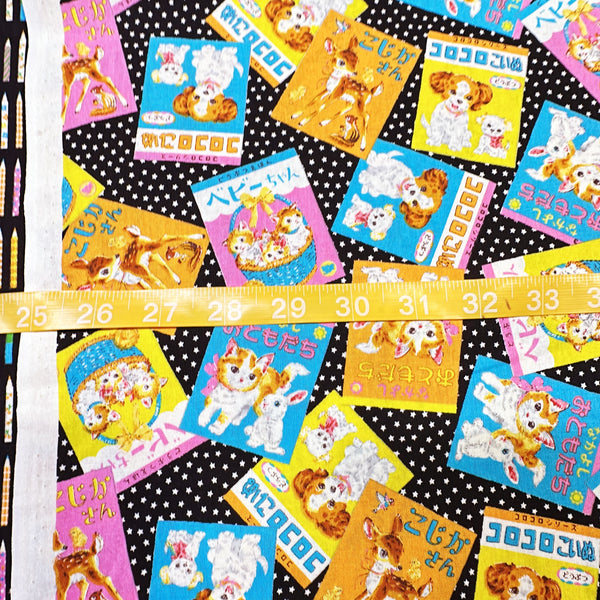 Scale of KoroKoro Animal Picture Books Cotton Fabric in Black by Koko Seki – quilt-weight cotton with retro animal storybook designs and Japanese text