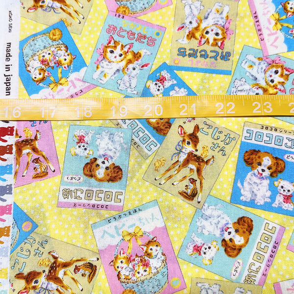 Scale of KoroKoro Animal Picture Books Cotton Fabric in Yellow by Koko Seki – quilt-weight cotton with retro animal storybook designs and Japanese text