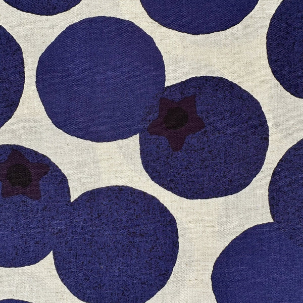 Close up of Large Blueberries Cotton Linen Blend Fabric by Cosmo Textiles, style AP65204 1A, featuring oversized blueberries, in natural