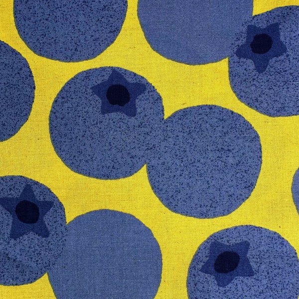 Close up of Large Blueberries Cotton Linen Blend Fabric by Cosmo Textiles, style AP65204 1C, featuring oversized blueberries, in yellow