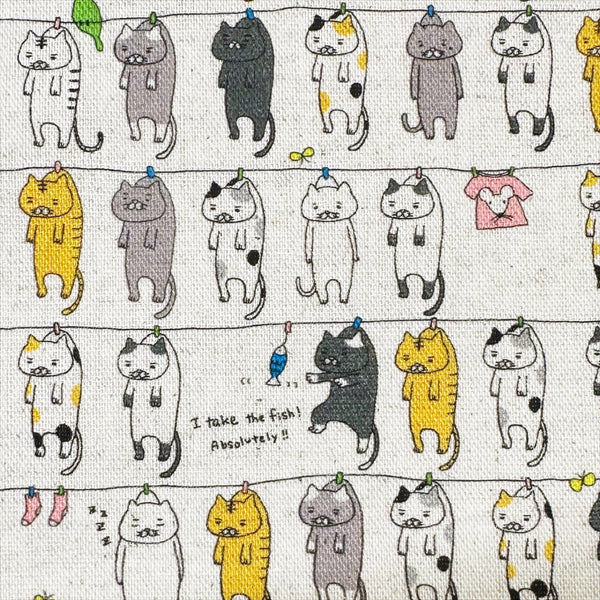 Close up of Laundry Cats canvas fabric in natural by Cotton Kobayashi, cotton linen blend with silly cats on a clothesline