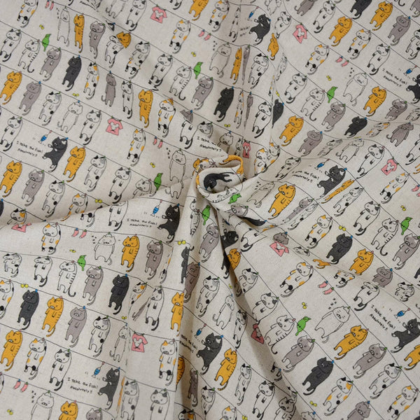 Stock photo of Laundry Cats canvas fabric in natural by Cotton Kobayashi, cotton linen blend with silly cats on a clothesline