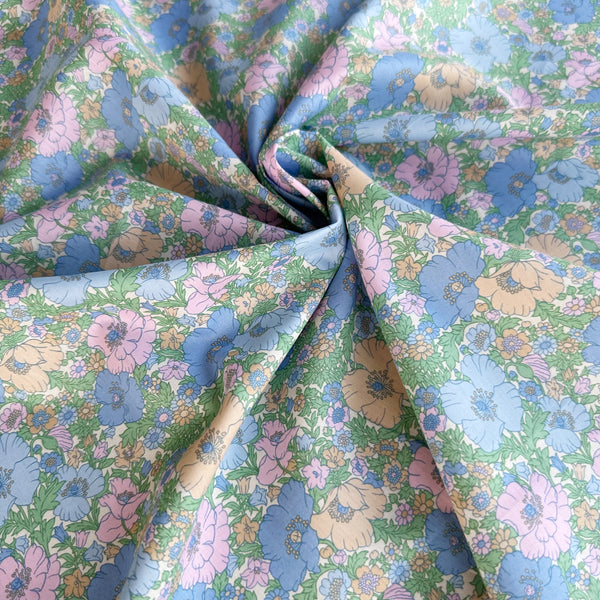 Meadow Song Tana Lawn fabric by Liberty Fabrics shown draped, Blue