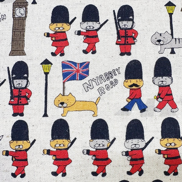 Close up of London Cats canvas fabric in natural cotton linen blend by Cotton Kobayashi featuring cats as royal guards