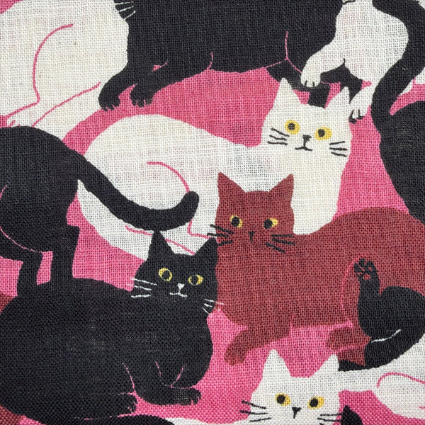 Close up of Lounge Cats textured cotton fabric by Sevenberry in pink, white, and black