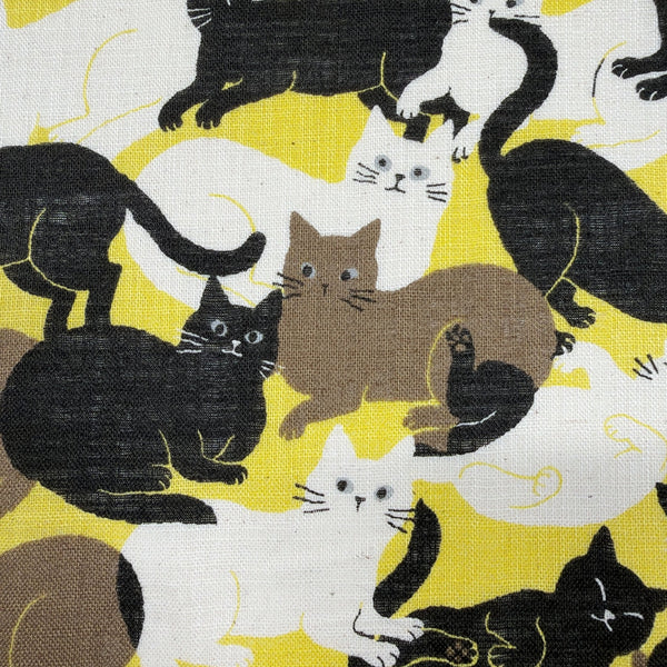 Close up of Lounge Cats textured cotton fabric by Sevenberry in yellow, white, and black