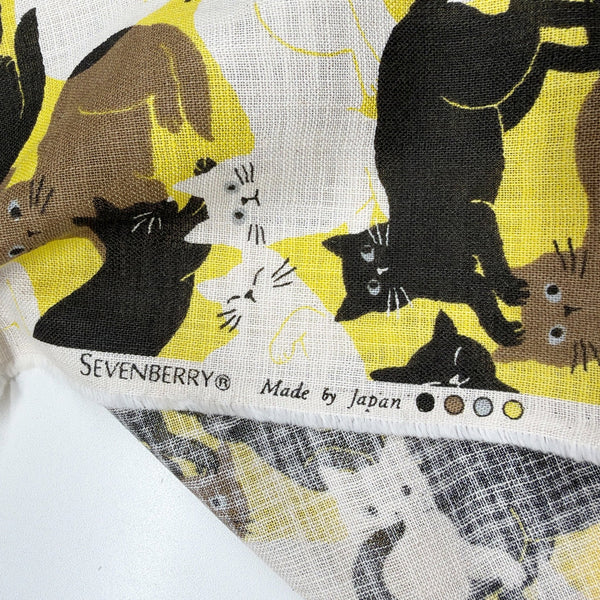 Selvage of Lounge Cats textured cotton fabric by Sevenberry in yellow, white, and black