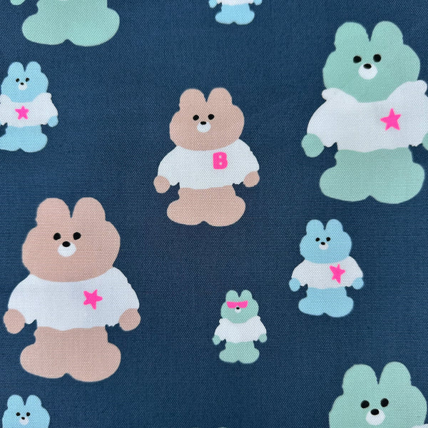 Close up of Mellow Friends Kuma Cotton Oxford Fabric in Blue featuring cute bears in shirts and hoodies with neon accents, imported from Japan.
