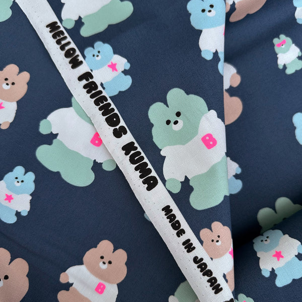 Selvage of Mellow Friends Kuma Cotton Oxford Fabric in Blue featuring cute bears in shirts and hoodies with neon accents, imported from Japan.