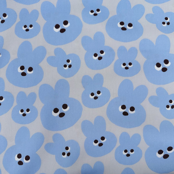 Mellow Friends Usagi Cotton Oxford Fabric in Blue featuring cute bunny faces in a playful print, imported from Japan.