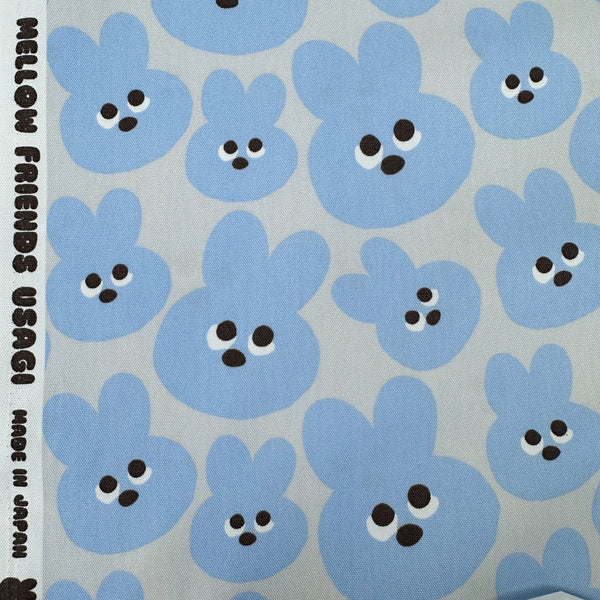Selvage of Mellow Friends Usagi Cotton Oxford Fabric in Blue featuring cute bunny faces in a playful print, imported from Japan.