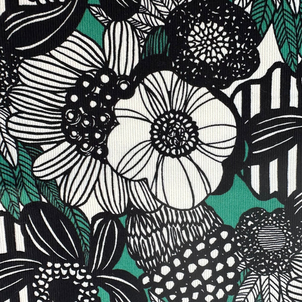 Close up of Modern Nordic Flower corduroy fabric by Cotton Kobayashi in green