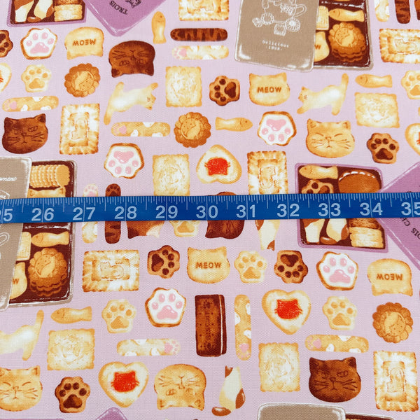 Scale of Neko Cookie Can cotton Oxford fabric by Komu Strada featuring cat-shaped cookies, biscuits, and cookie tins on a pink background
