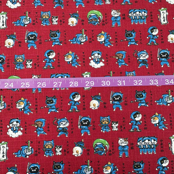 Scale of Neko Ninja cotton dobby fabric in crimson by Cosmo Textiles Imported from Japan