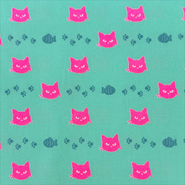 Neon Cat Cotton Oxford Fabric in Aqua featuring a playful print of fish, paws, and neon cat faces, imported from Japan.