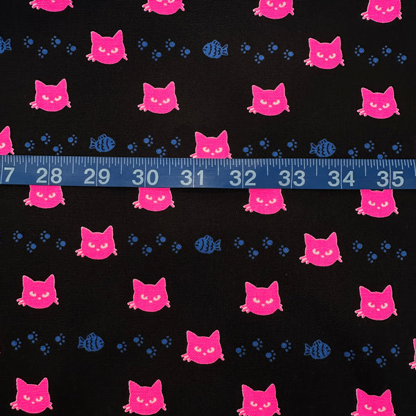 Scale of Neon Cat Cotton Oxford Fabric in Black featuring a playful print of fish, paws, and neon cat faces, imported from Japan.