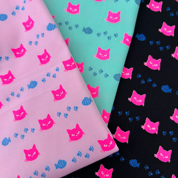 Neon Cat Cotton Oxford Fabric featuring a playful print of fish, paws, and neon cat faces, imported from Japan.