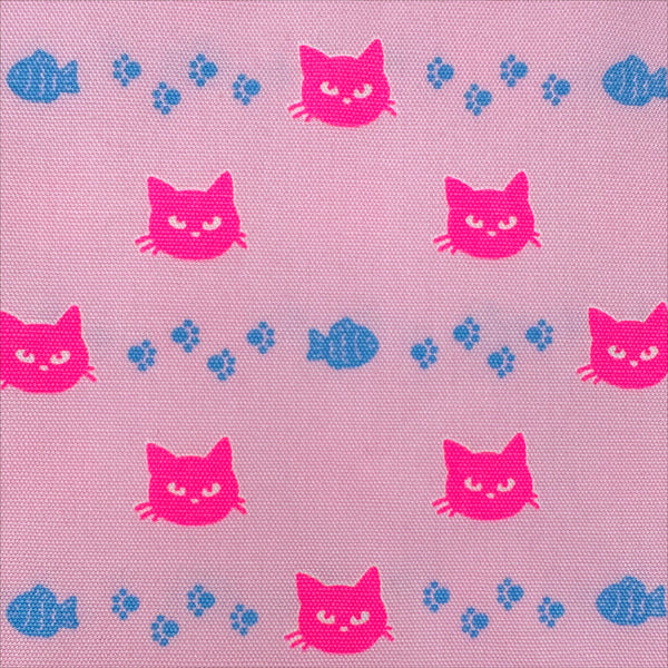 Close up of Neon Cat Cotton Oxford Fabric in Pink featuring a playful print of fish, paws, and neon cat faces, imported from Japan.