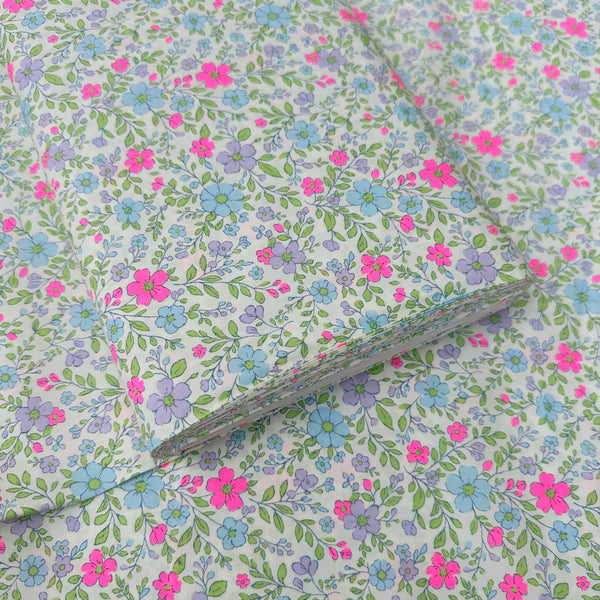 Bolt of Neon Flower Cotton Broadcloth Fabric in Natural featuring a vibrant floral print with neon accents, imported from Japan.