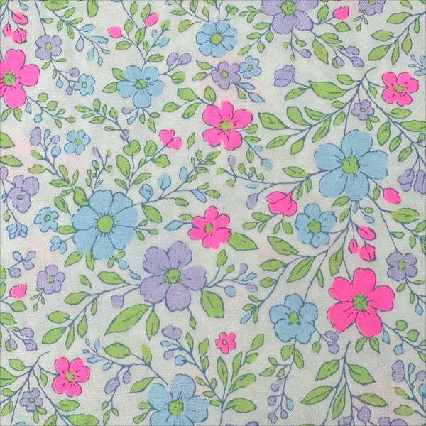 Close up of Neon Flower Cotton Broadcloth Fabric in Natural featuring a vibrant floral print with neon accents, imported from Japan.