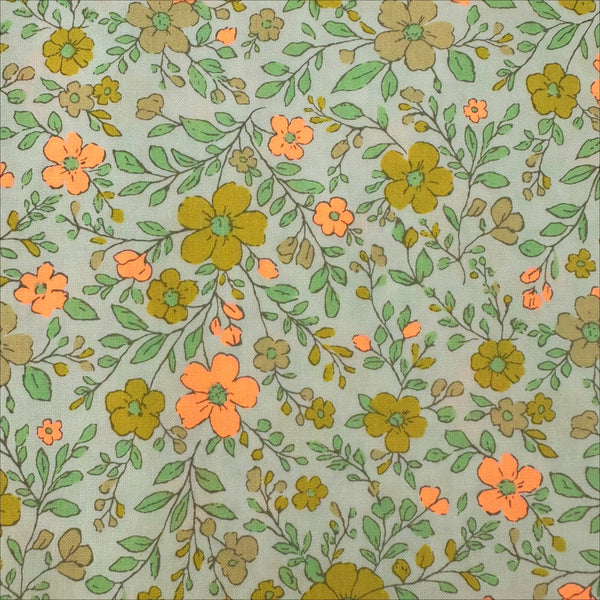 Close up of Neon Flower Cotton Broadcloth Fabric in Orange featuring a vibrant floral print with neon accents, imported from Japan.