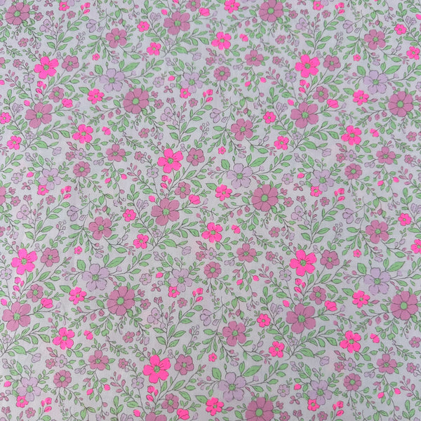 Neon Flower Cotton Broadcloth Fabric in Pink featuring a vibrant floral print with neon accents, imported from Japan.