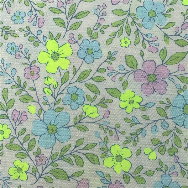 Close up of Neon Flower Cotton Broadcloth Fabric in Yellow featuring a vibrant floral print with neon accents, imported from Japan.