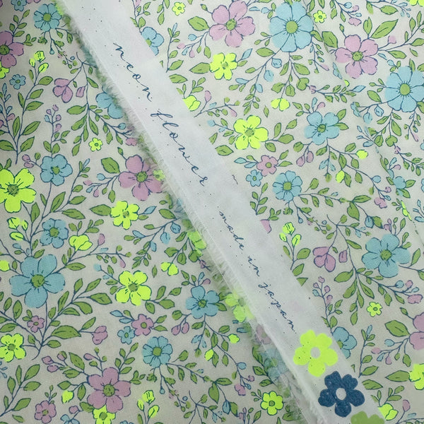 Selvage of Neon Flower Cotton Broadcloth Fabric in Yellow featuring a vibrant floral print with neon accents, imported from Japan.
