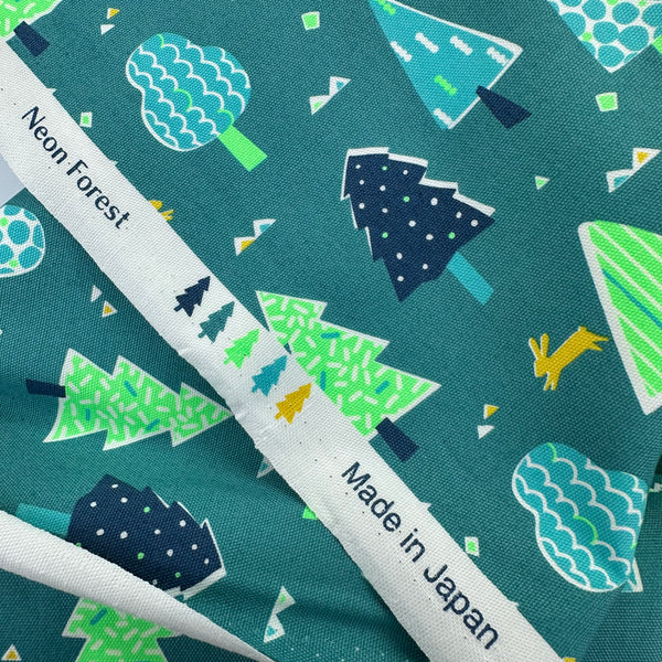 Selvage of Neon Forest Cotton Oxford Fabric in Neon Green featuring a vibrant forest-inspired print with neon colors, imported from Japan.