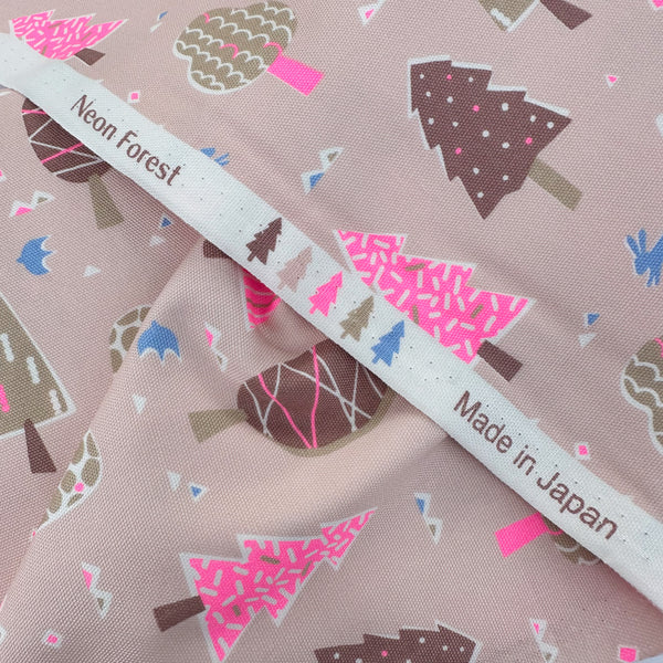 Selvage of Neon Forest Cotton Oxford Fabric in Pink featuring a vibrant forest-inspired print with neon colors, imported from Japan.