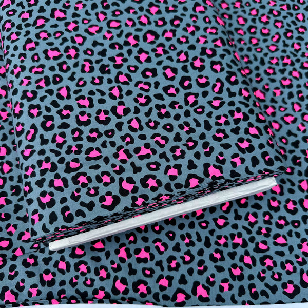 Bolt of Neon Leopard Cotton Fabric in Gray and Neon Pink featuring a bold leopard print with neon accents, imported from Japan.