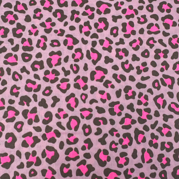Close up of Neon Leopard Cotton Fabric in Pink featuring a bold leopard print with neon accents, imported from Japan.
