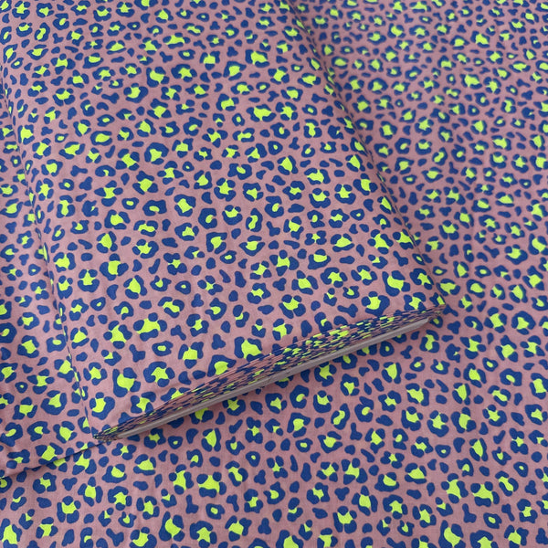 Bolt of Neon Leopard Cotton Fabric in Purple featuring a bold leopard print with neon accents, imported from Japan.