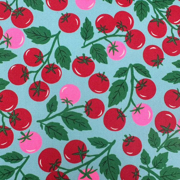 Close up of Neon Tomato Cotton Oxford Fabric in Blue featuring a playful tomato print with neon accents, imported from Japan.