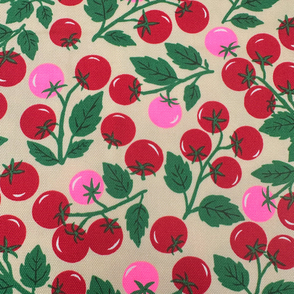 Close up of Neon Tomato Cotton Oxford Fabric in Cream featuring a playful tomato print with neon accents, imported from Japan.