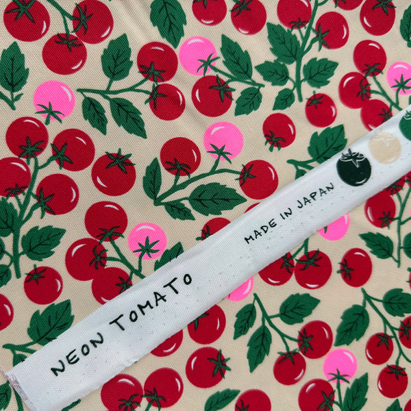 Selvage of Neon Tomato Cotton Oxford Fabric in Cream featuring a playful tomato print with neon accents, imported from Japan.