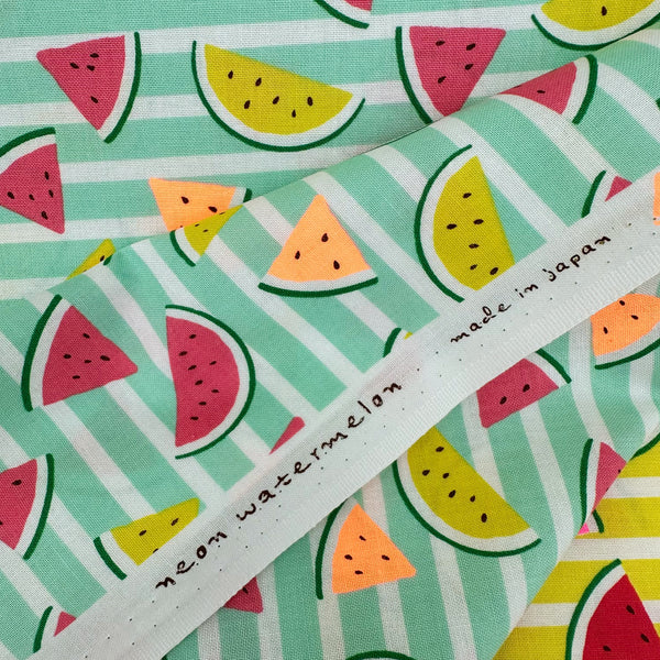 Selvage of Neon Watermelon Cotton Fabric in Mint featuring a bright watermelon print with neon accents, imported from Japan.