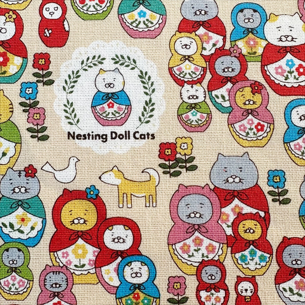 Close up of Nesting Dolls Cats Cotton Canvas Fabric by Cotton Kobayashi, style KTS-7177A, featuring cat nesting doll illustrations, in beige, imported from Japan