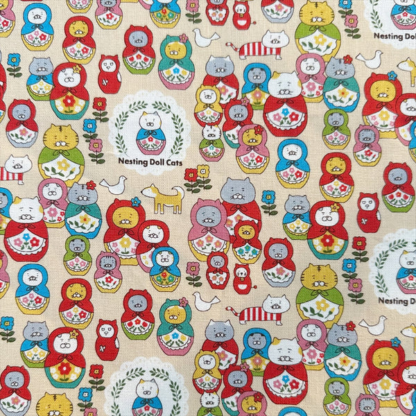 Nesting Dolls Cats Cotton Canvas Fabric by Cotton Kobayashi, style KTS-7177A, featuring cat nesting doll illustrations, in beige, imported from Japan