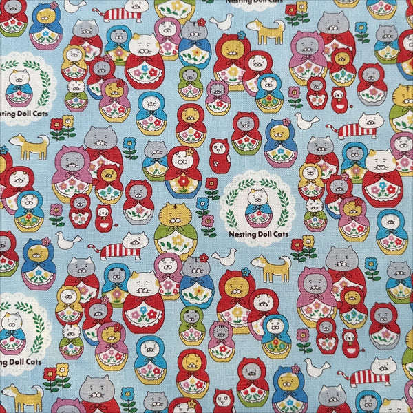 Nesting Dolls Cats Cotton Canvas Fabric by Cotton Kobayashi, style KTS-7177C, featuring cat nesting doll illustrations, in blue, imported from Japan