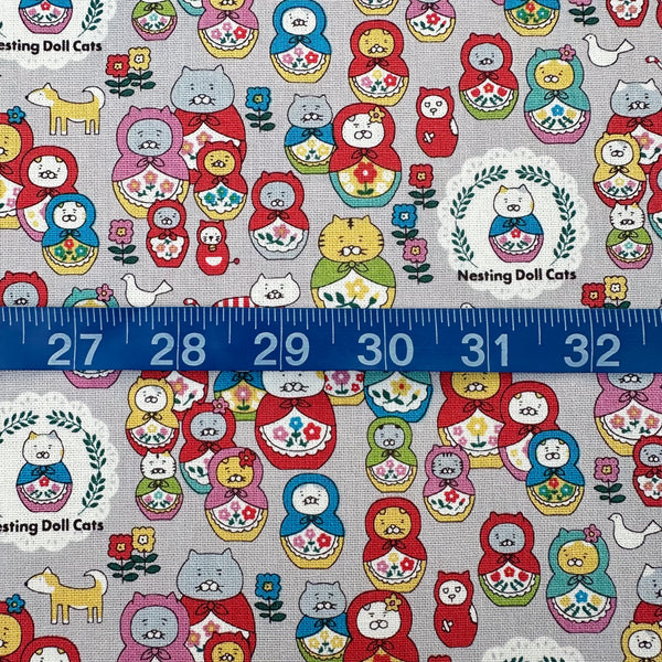 Scale of Nesting Dolls Cats Cotton Canvas Fabric by Cotton Kobayashi, style KTS-7177D, featuring cat nesting doll illustrations, in gray, imported from Japan